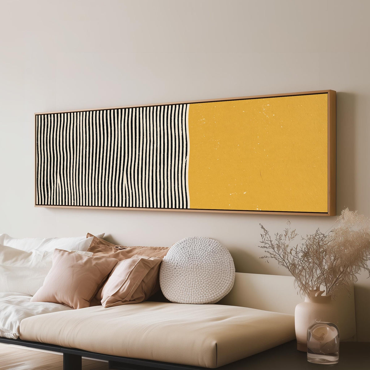 Black wavy stripes beside a mustard block long horizontal canvas print above a sofa in a living room