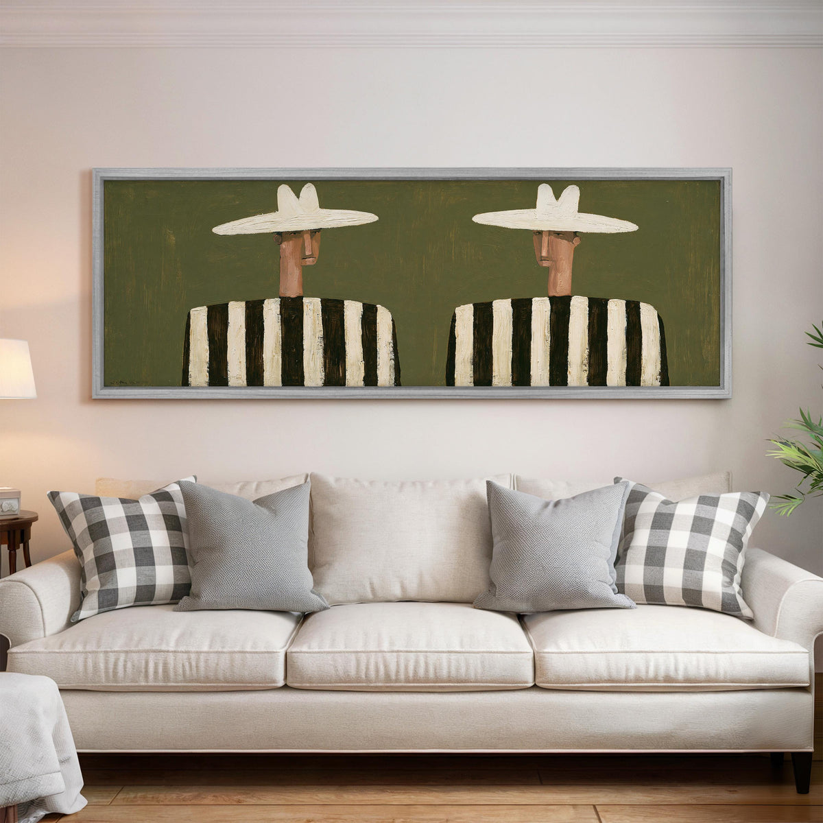Two figures in striped shirts panoramic canvas print above a white sofa in a bright living room