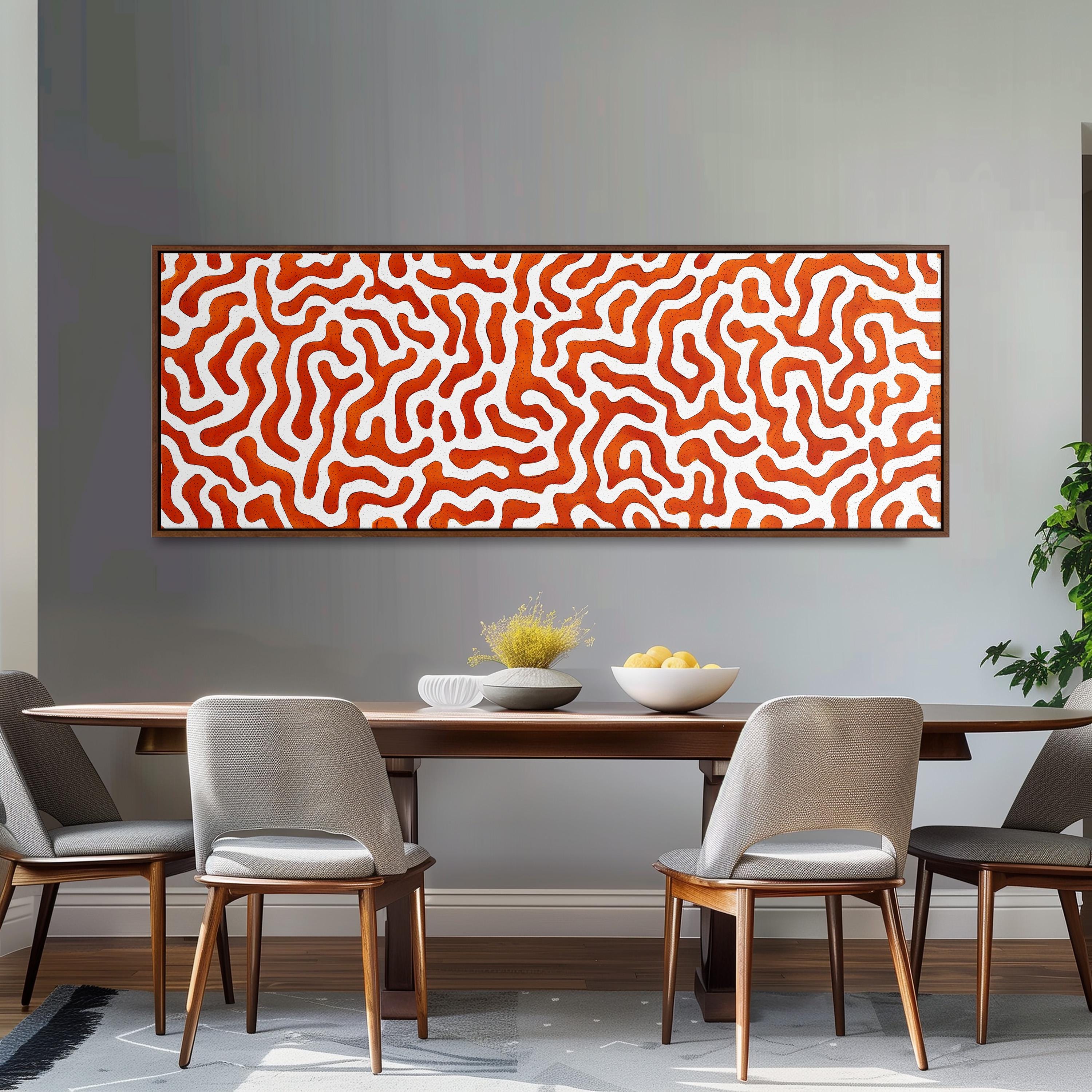 a dining room with a wooden table and four chairs. Above the table, there is a large abstract painting with a red and white color scheme. The painting is framed and hangs on the wall above the table.