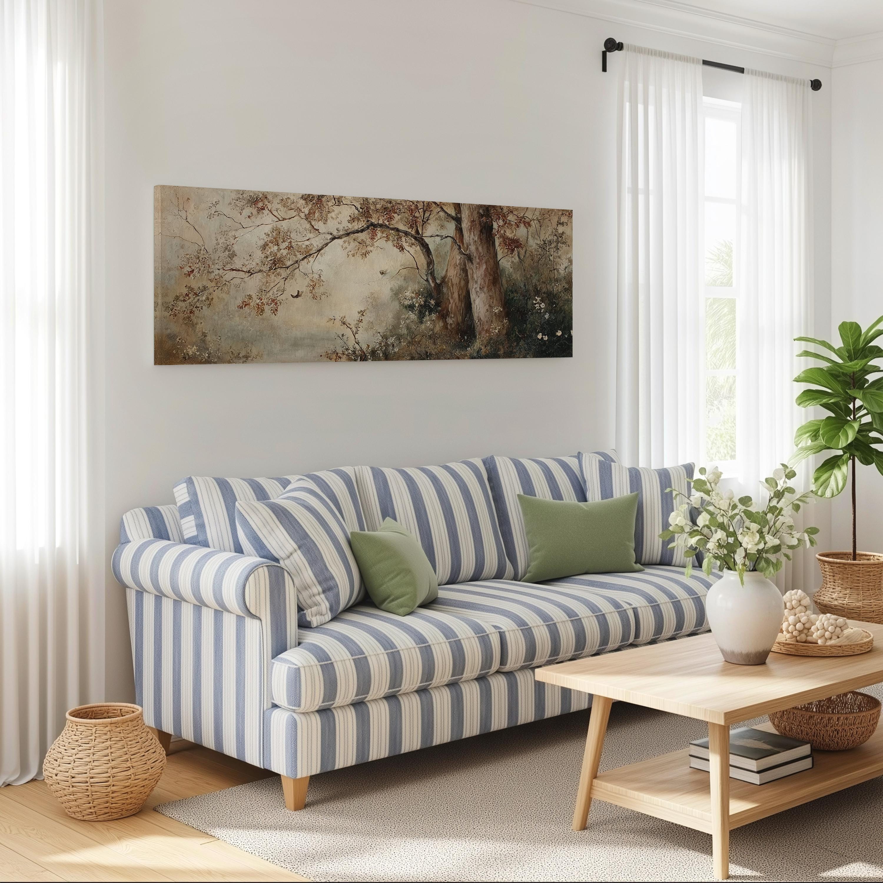 a cozy living room with a striped blue and white sofa, a wooden coffee table, and a large painting of a tree on the wall.