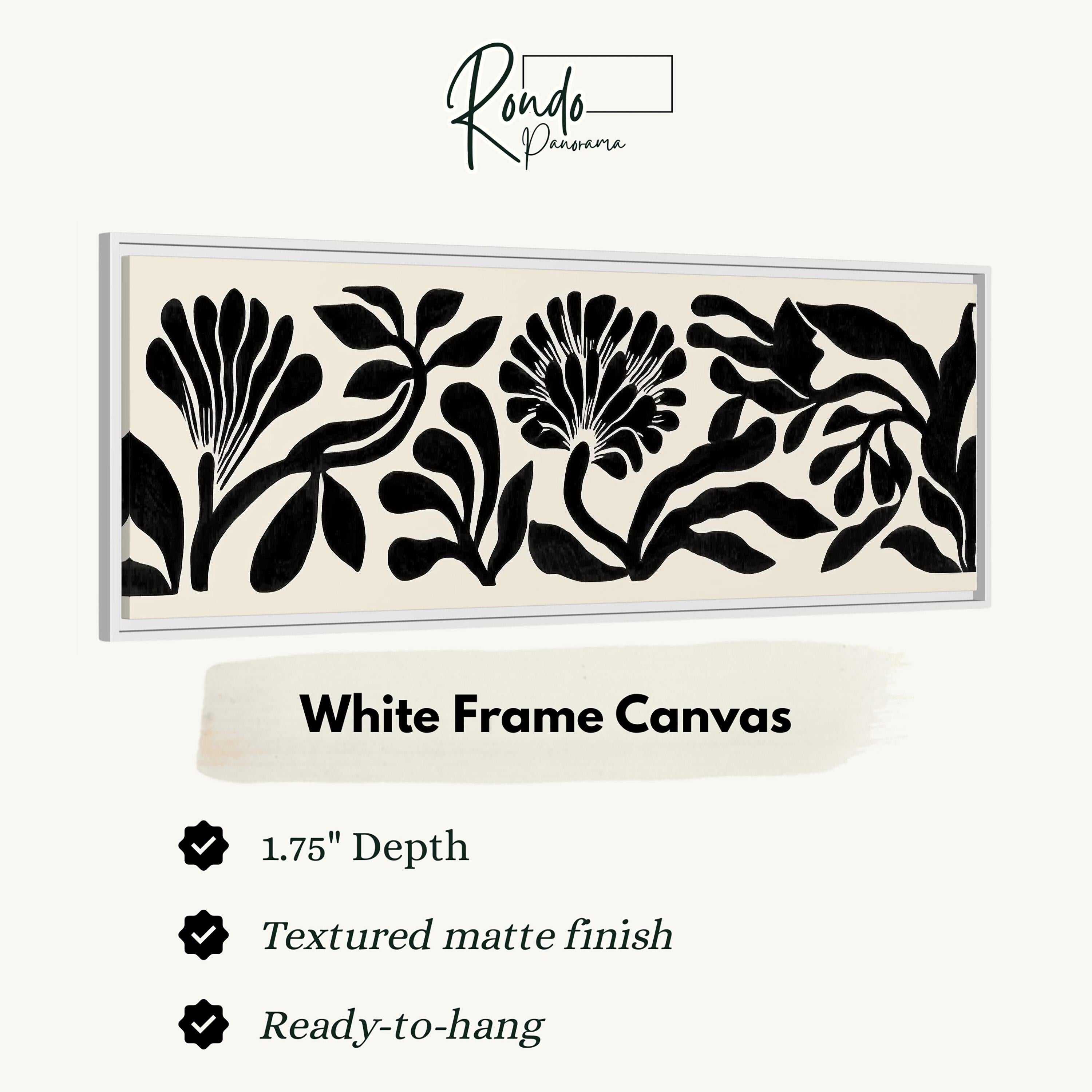 a white frame canvas with a black and white floral design.