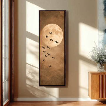 a large framed painting of a flock of birds flying against a backdrop of a full moon.