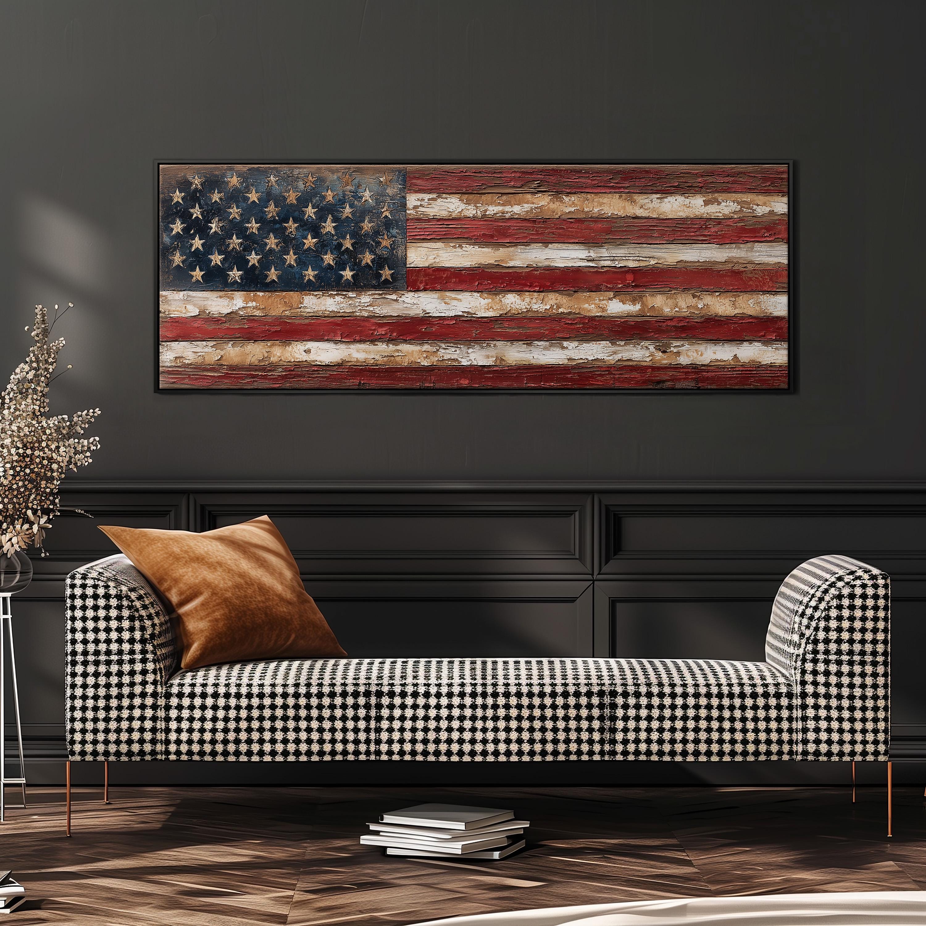a large American flag displayed on a wall above a black and white checkered sofa with a brown throw pillow.