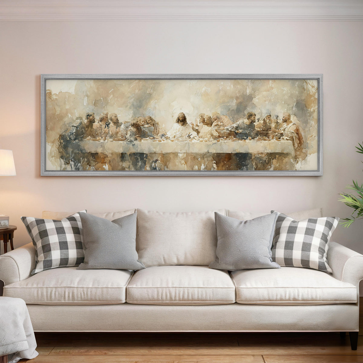 The Last Supper in soft gold tones panoramic canvas print above a white sofa in a bright living room