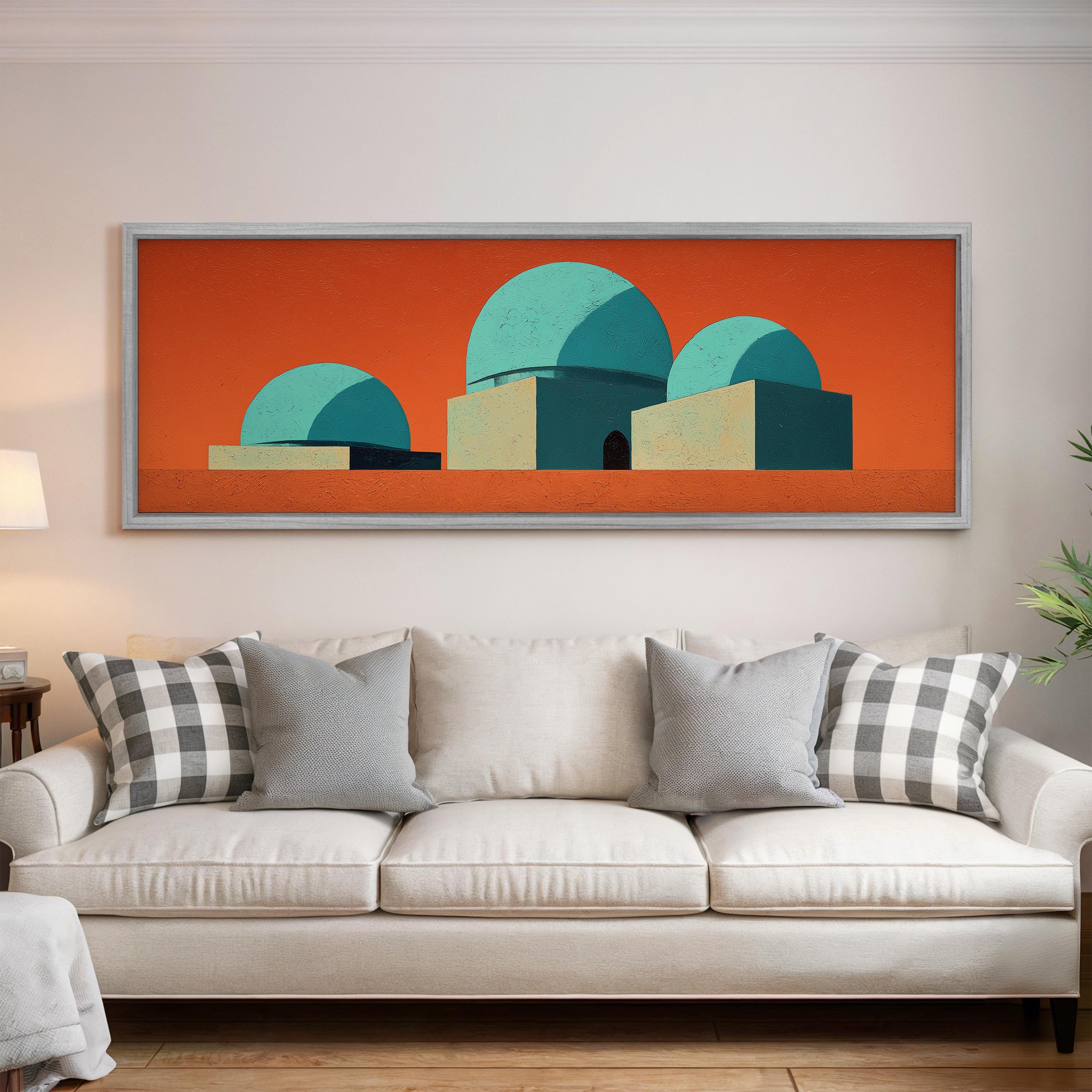 a large, colorful abstract painting hanging on a white wall above a white couch with gray and white patterned pillows.