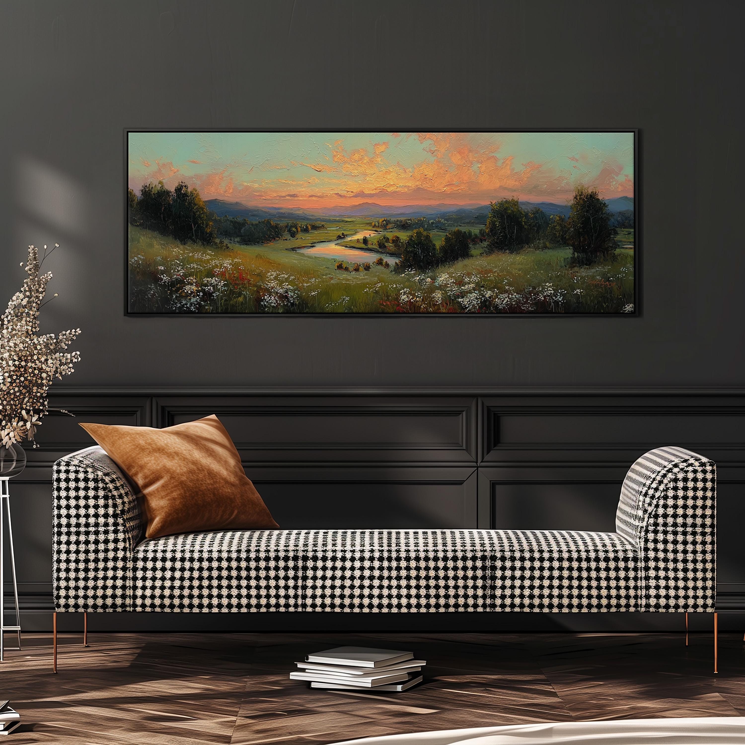 a large landscape painting hanging on a wall above a black and white checkered sofa in a living room setting.