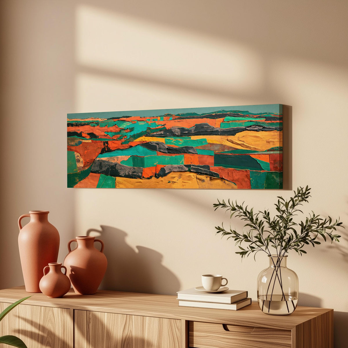 Abstract patchwork terrain in orange and teal long horizontal canvas print above a wooden sideboard