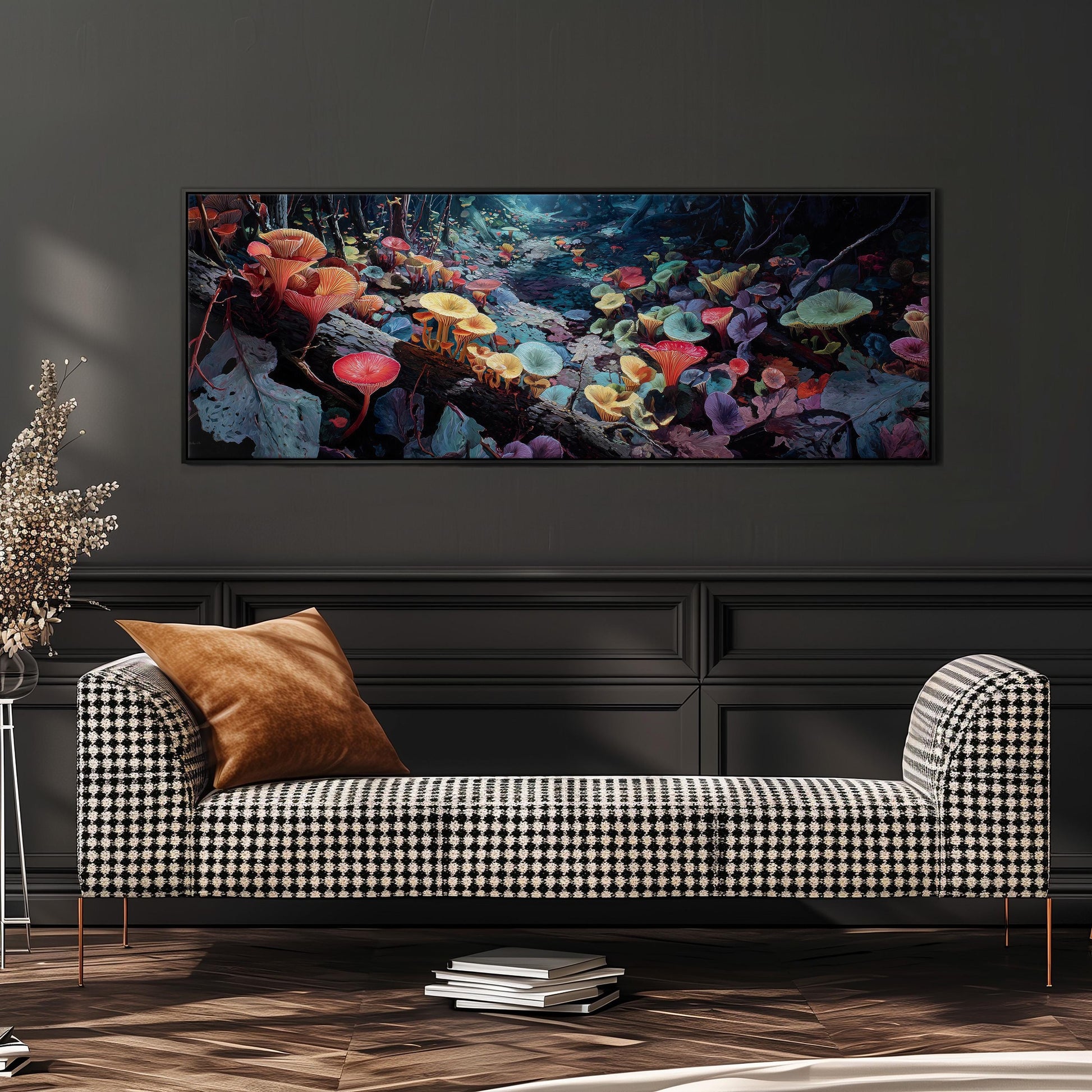 a checkered sofa with a stack of books on the floor in front of it, and a large framed painting of colorful mushrooms hanging on the wall above the sofa.