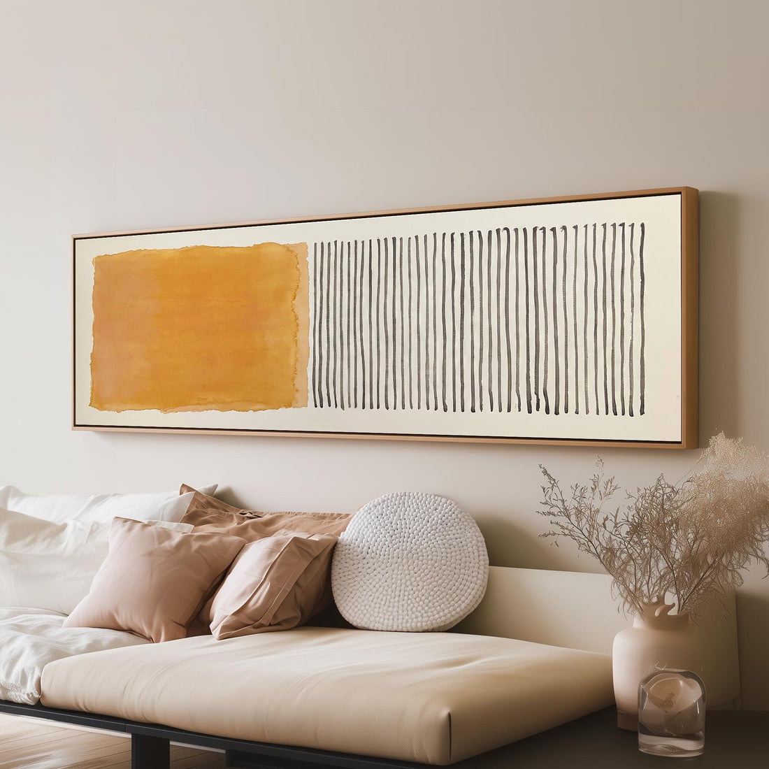 Gold wash beside charcoal line stripes long horizontal canvas print above a sofa in a living room