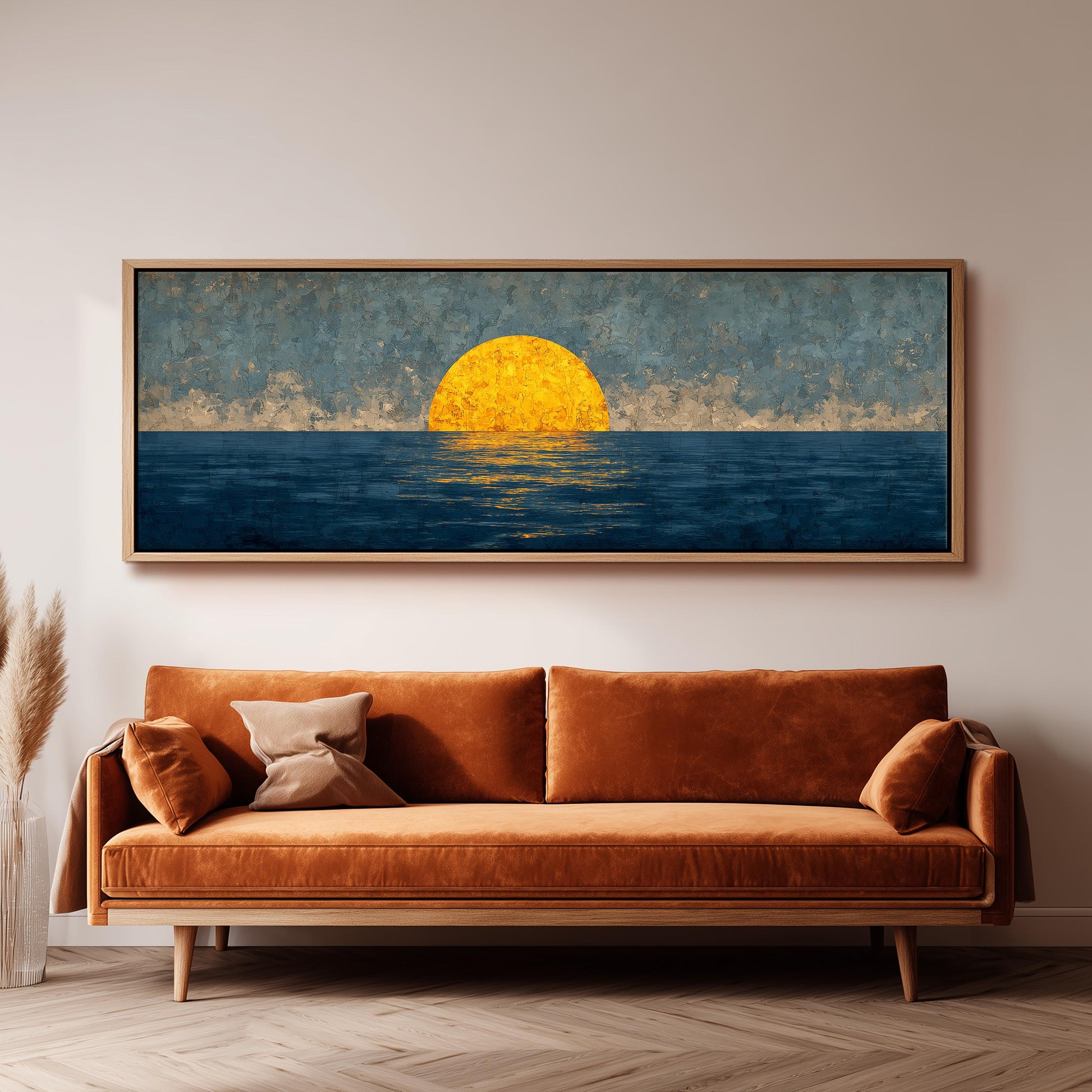a large, rectangular painting hanging on a wall above a brown sofa.