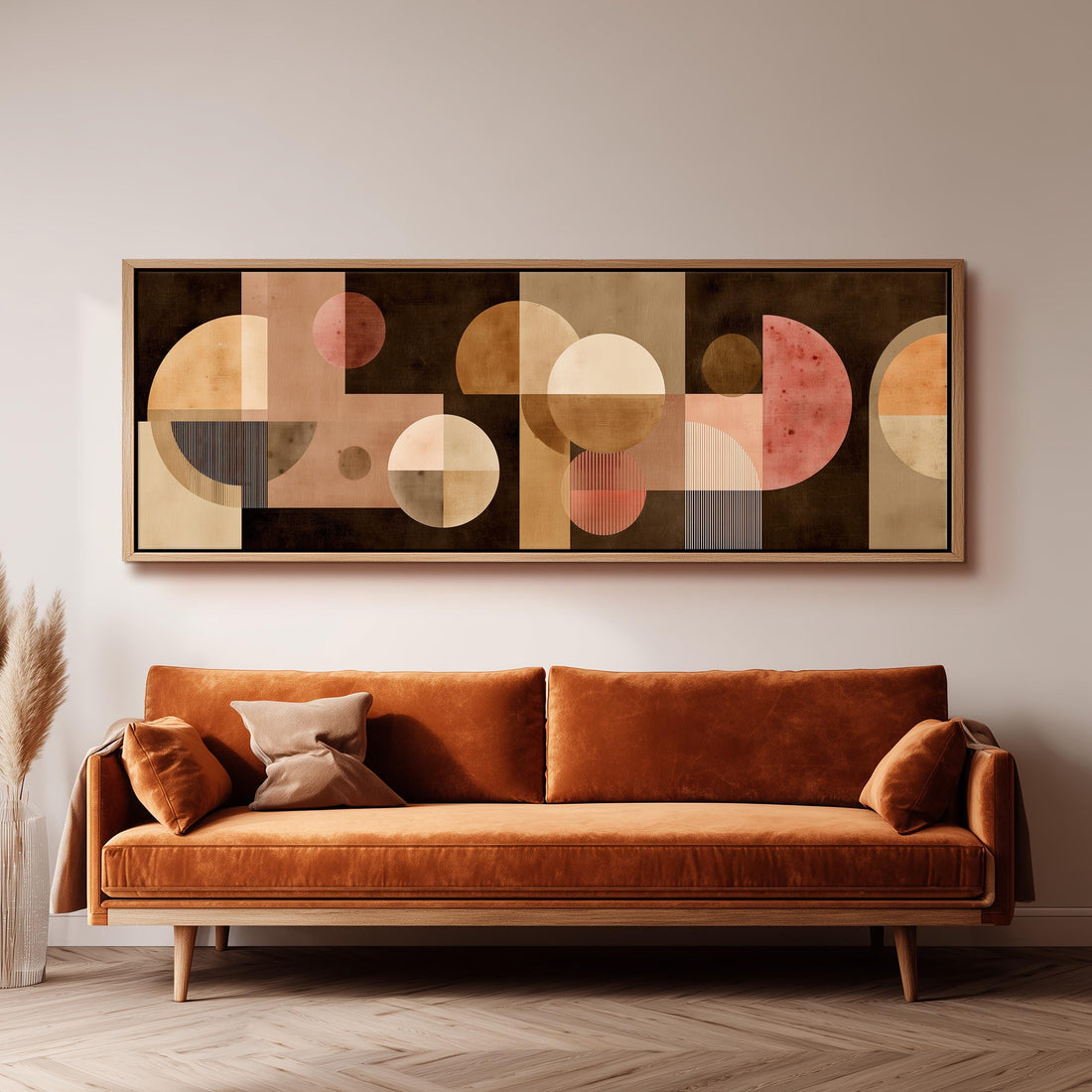 a large abstract painting hanging on a wall above a brown sofa with two pillows.