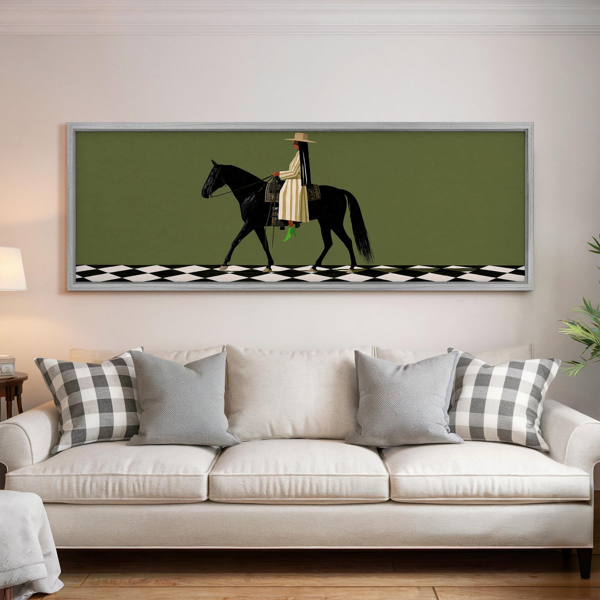 Woman riding a black horse on a checkerboard panoramic canvas print above a white sofa in a bright living room