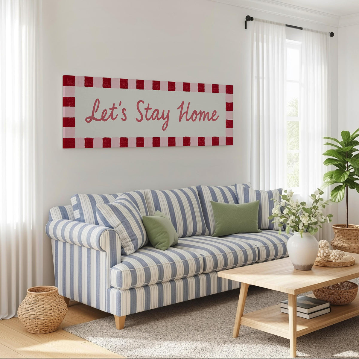 Let's stay home sign with a red checked border long horizontal canvas print above a striped sofa in a coastal living room
