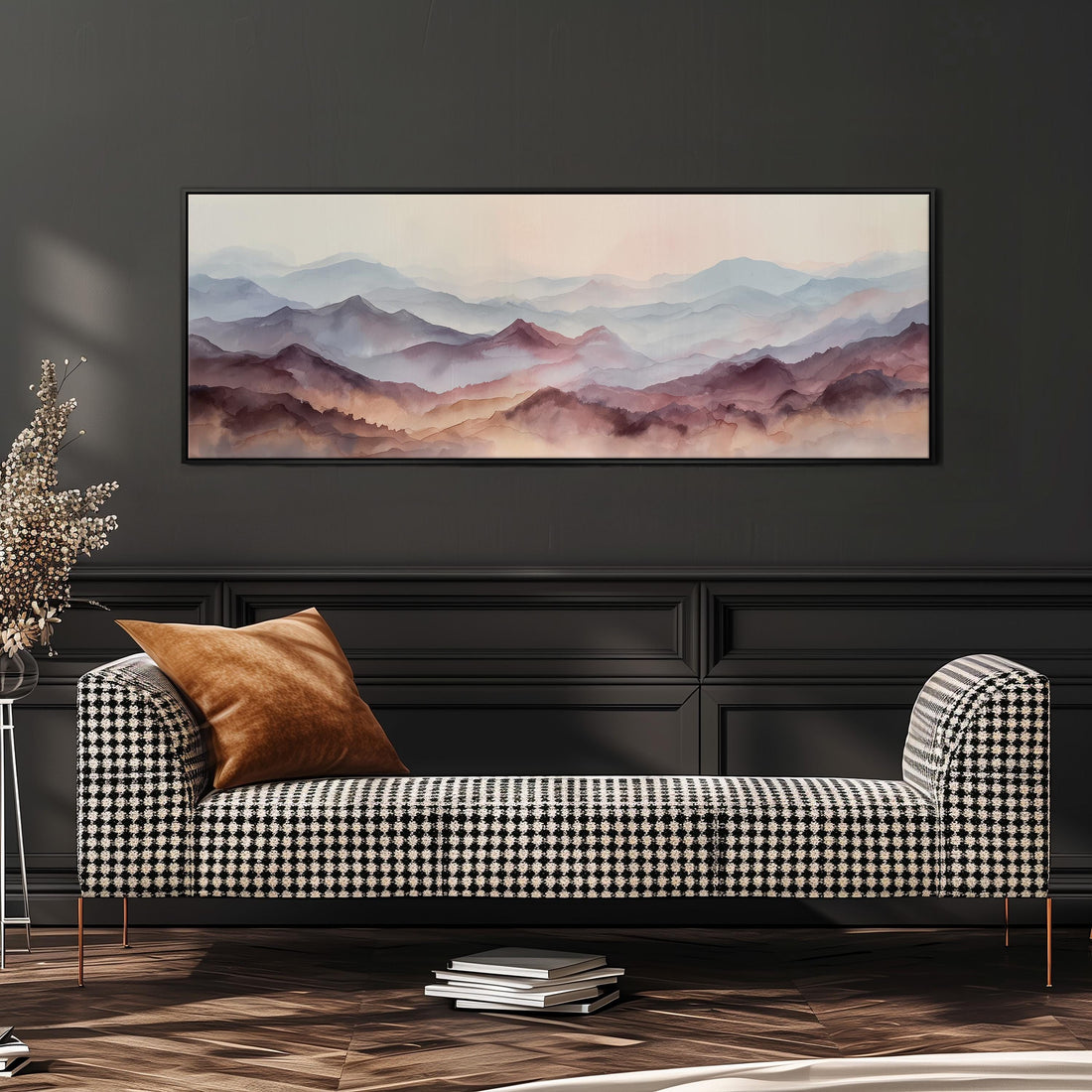 a large, framed painting of a mountain landscape hanging on a wall above a brown sofa with orange cushions.