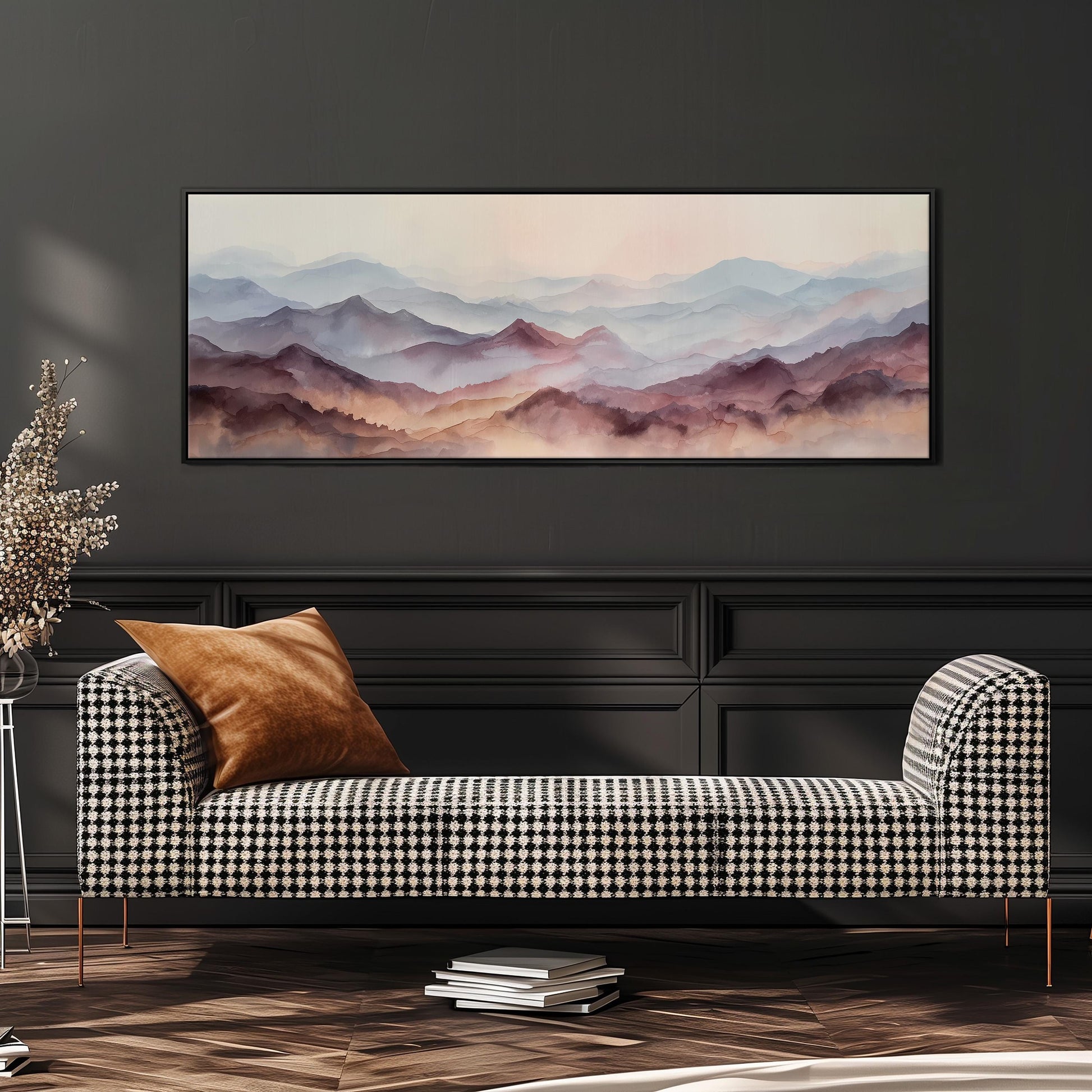a large, framed painting of a mountainous landscape hanging on a dark wall above a black and white checkered sofa with a brown throw pillow.