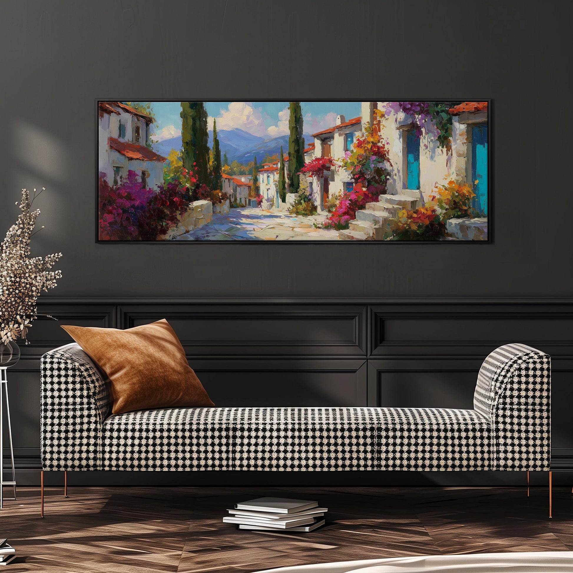 a large, colorful painting of a village scene hanging on a wall above a black and white checkered sofa.