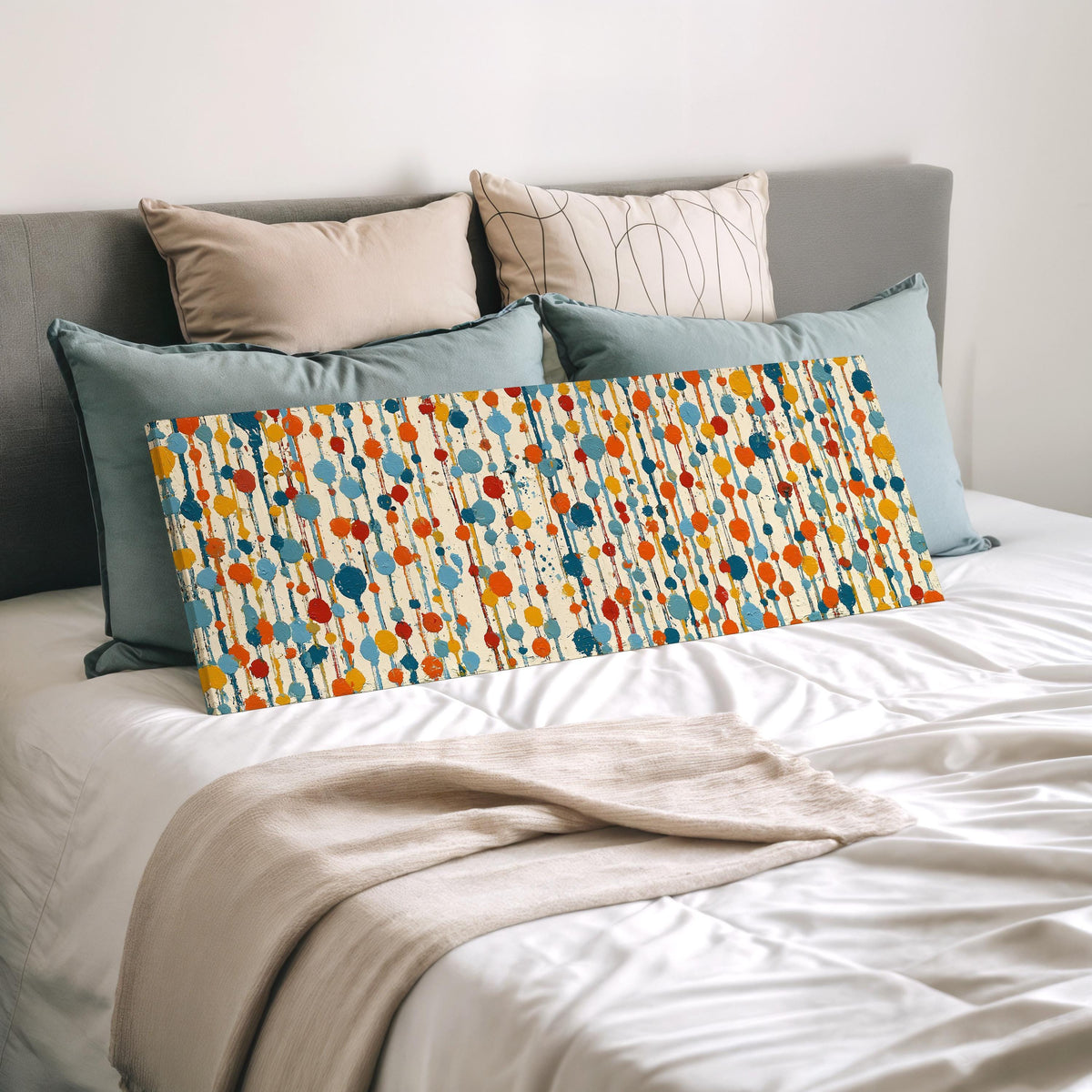Strings of colorful polka dot blooms wide panoramic canvas print laid on a bed to show its size