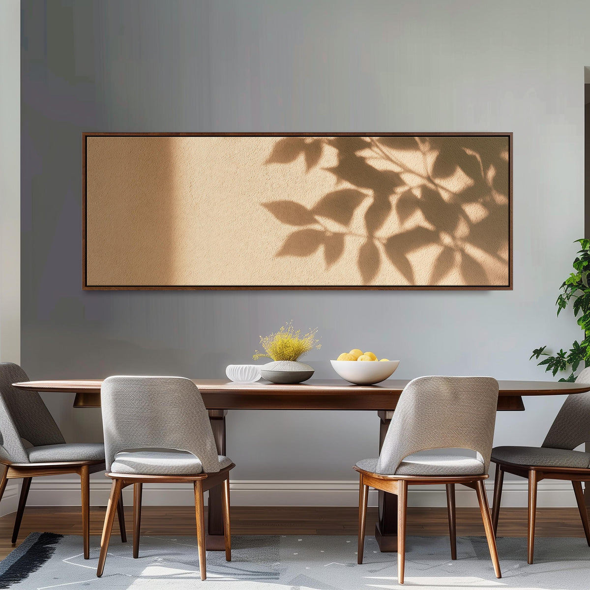 Leaf shadows on a golden plaster wall long horizontal canvas print above a dining table