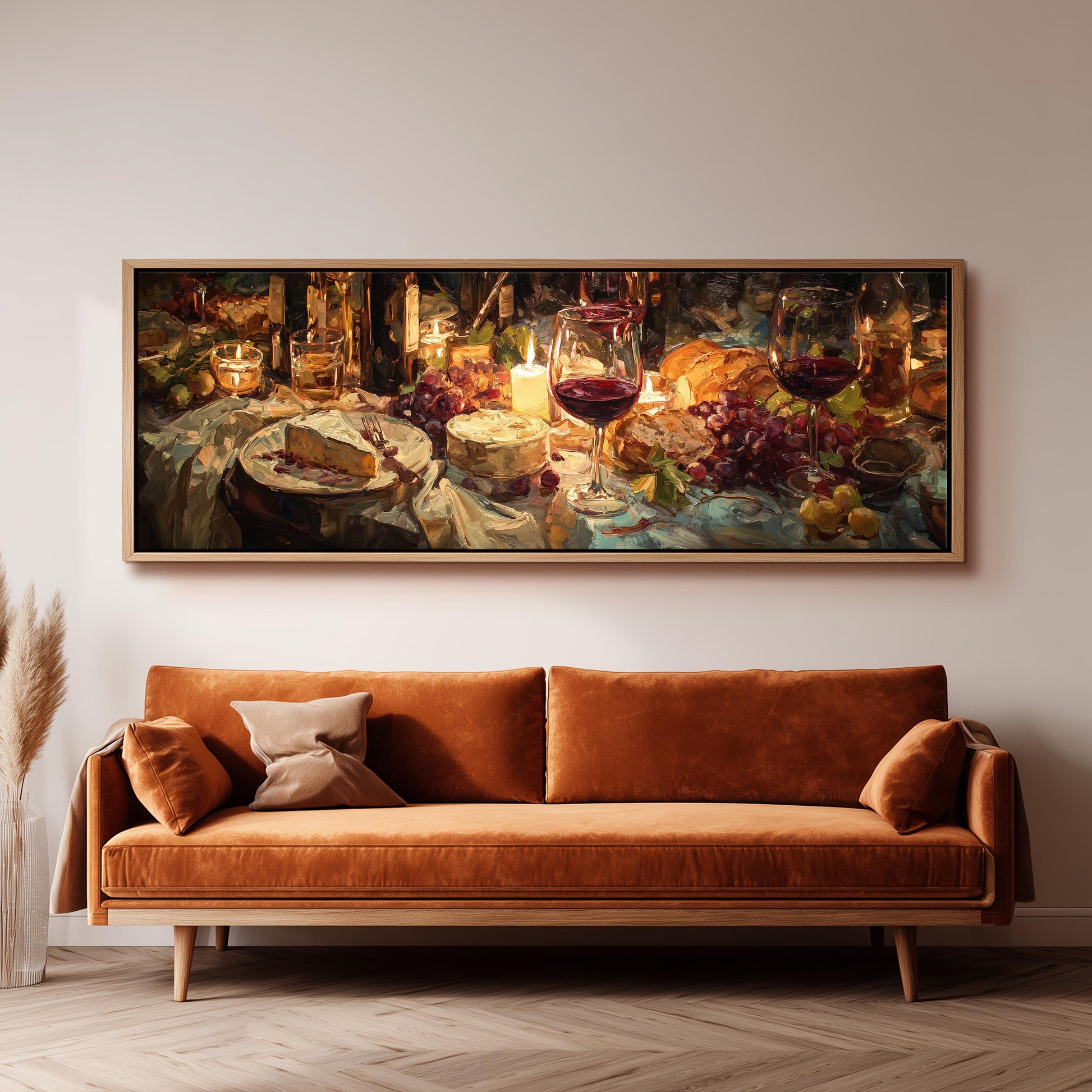a large painting of a table with various food items, including wine glasses, grapes, and cheese, hanging on a wall above a brown sofa.