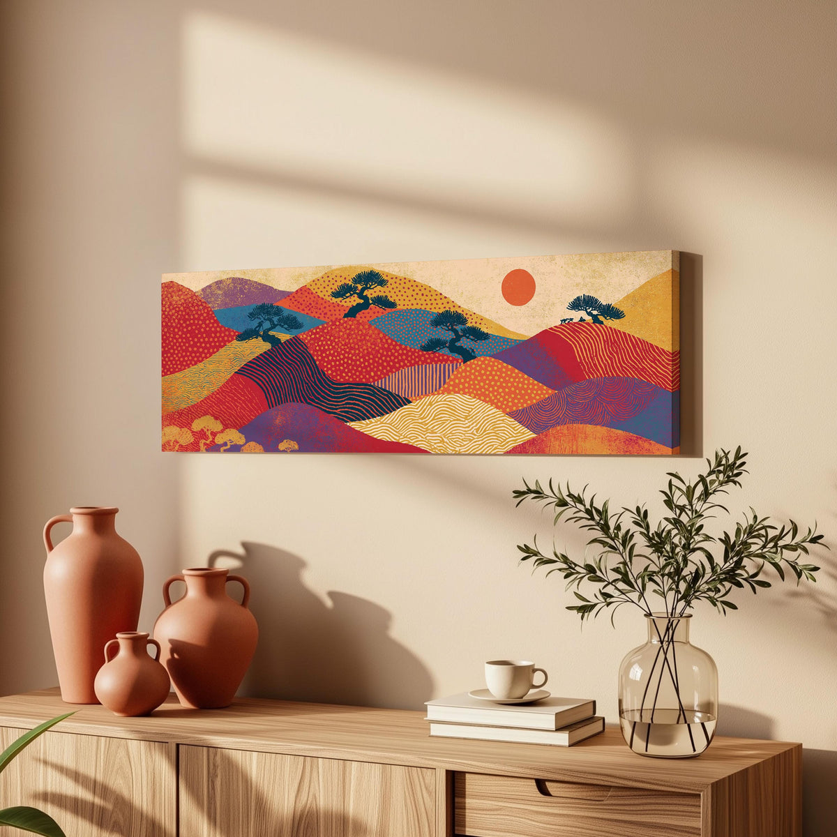 Bonsai trees on patterned hills with a red sun long horizontal canvas print above a wooden sideboard