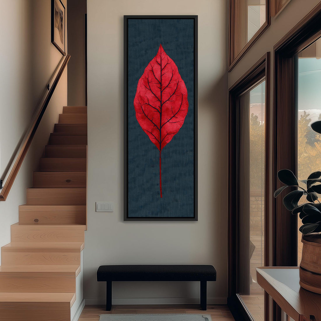 a hallway with a large red leaf artwork hanging on the wall, a wooden staircase, a black bench, and a potted plant.
