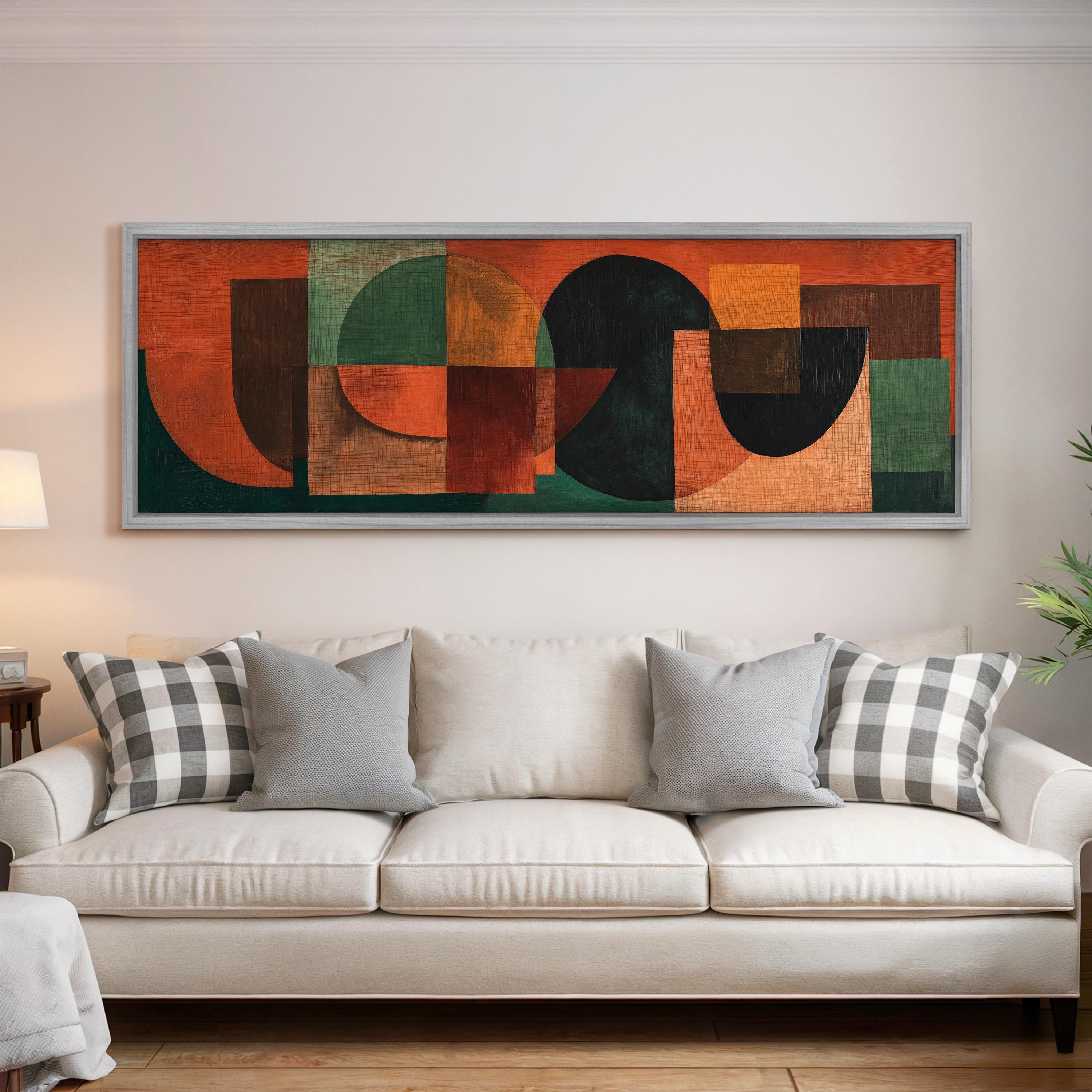 a large abstract painting hanging on a white wall above a white couch with gray and white patterned pillows.