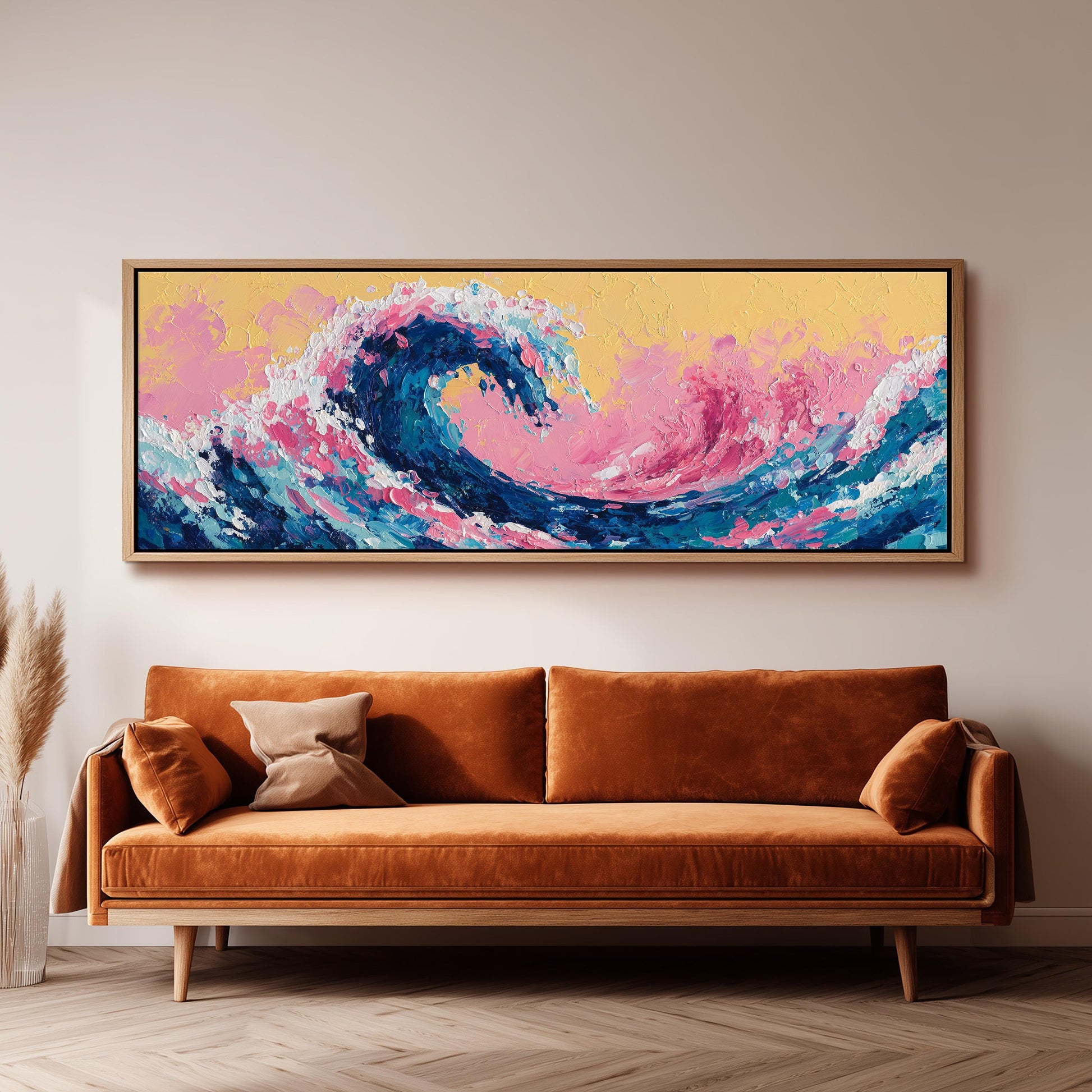 a large, vibrant painting of a wave hanging on a wall above a brown sofa.