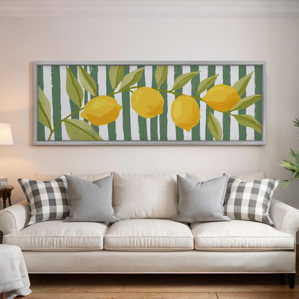 Lemon branch on green stripes panoramic canvas print above a white sofa in a bright living room
