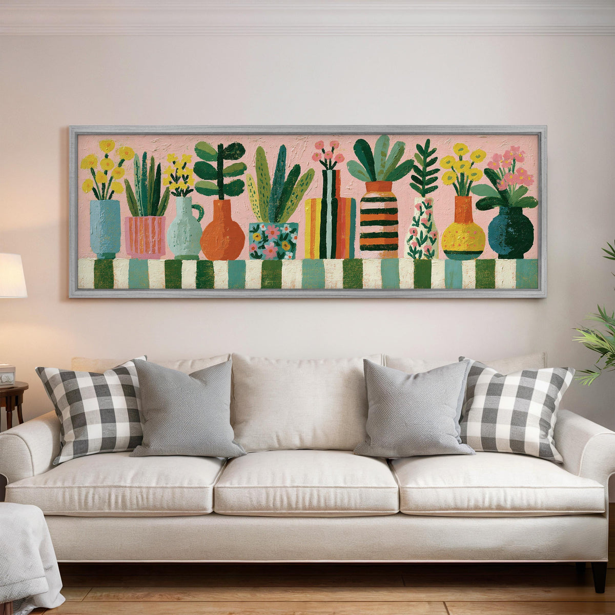 Row of boho potted plants panoramic canvas print above a white sofa in a bright living room