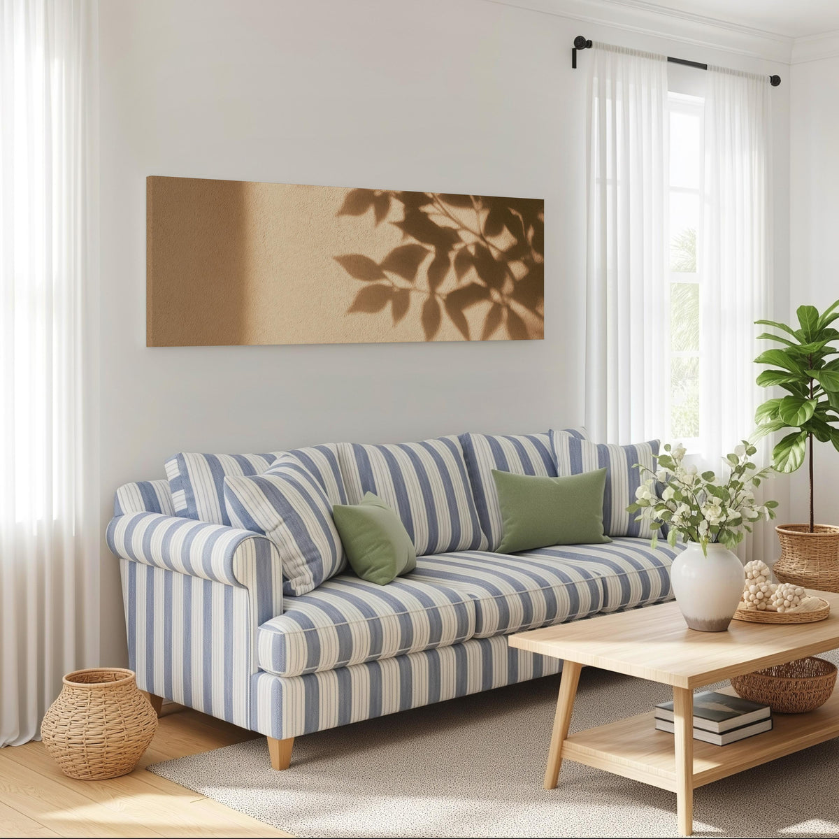 Leaf shadows on a golden plaster wall long horizontal canvas print above a striped sofa in a coastal living room