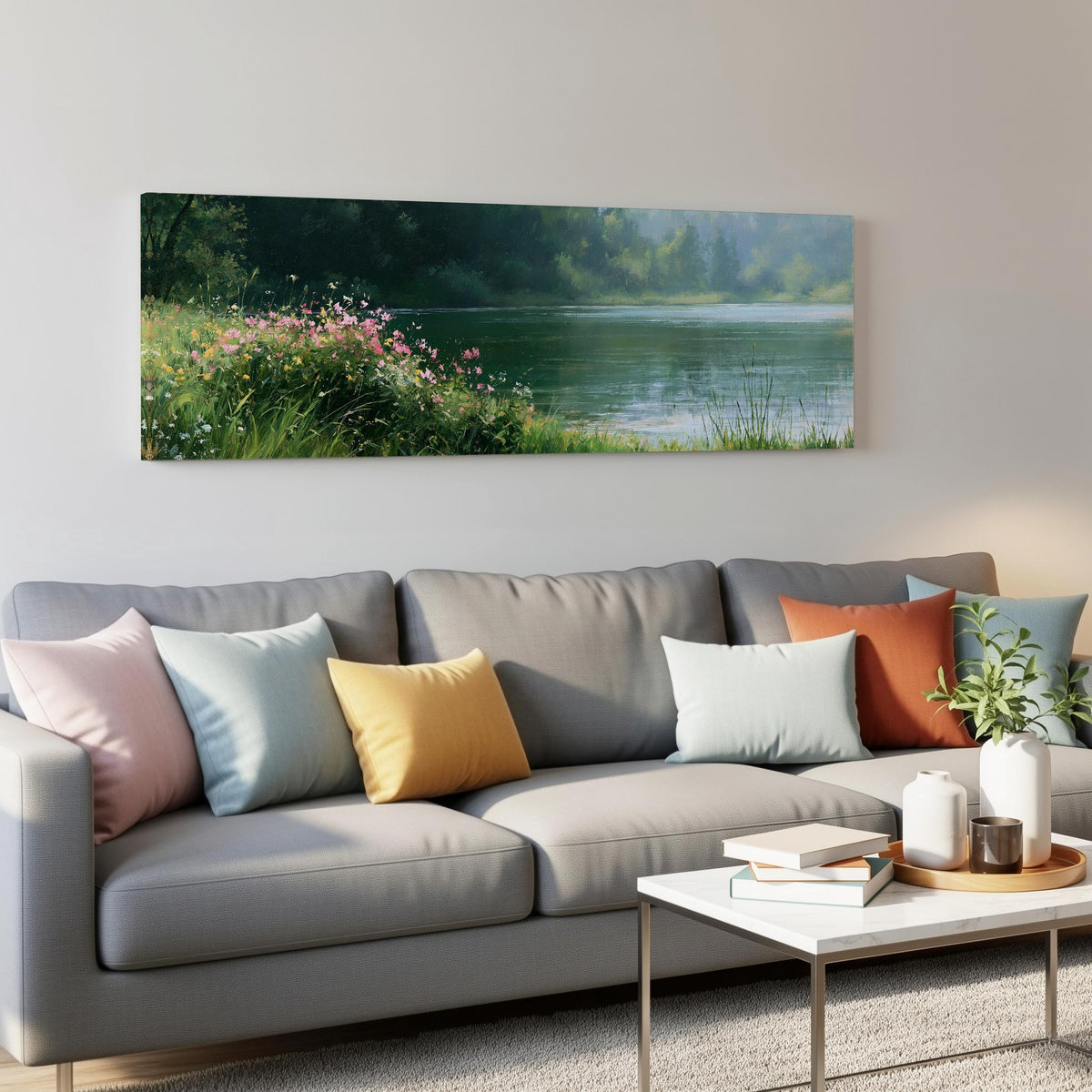 Pink wildflowers on a green lakeshore panoramic canvas print above a grey sofa in a living room