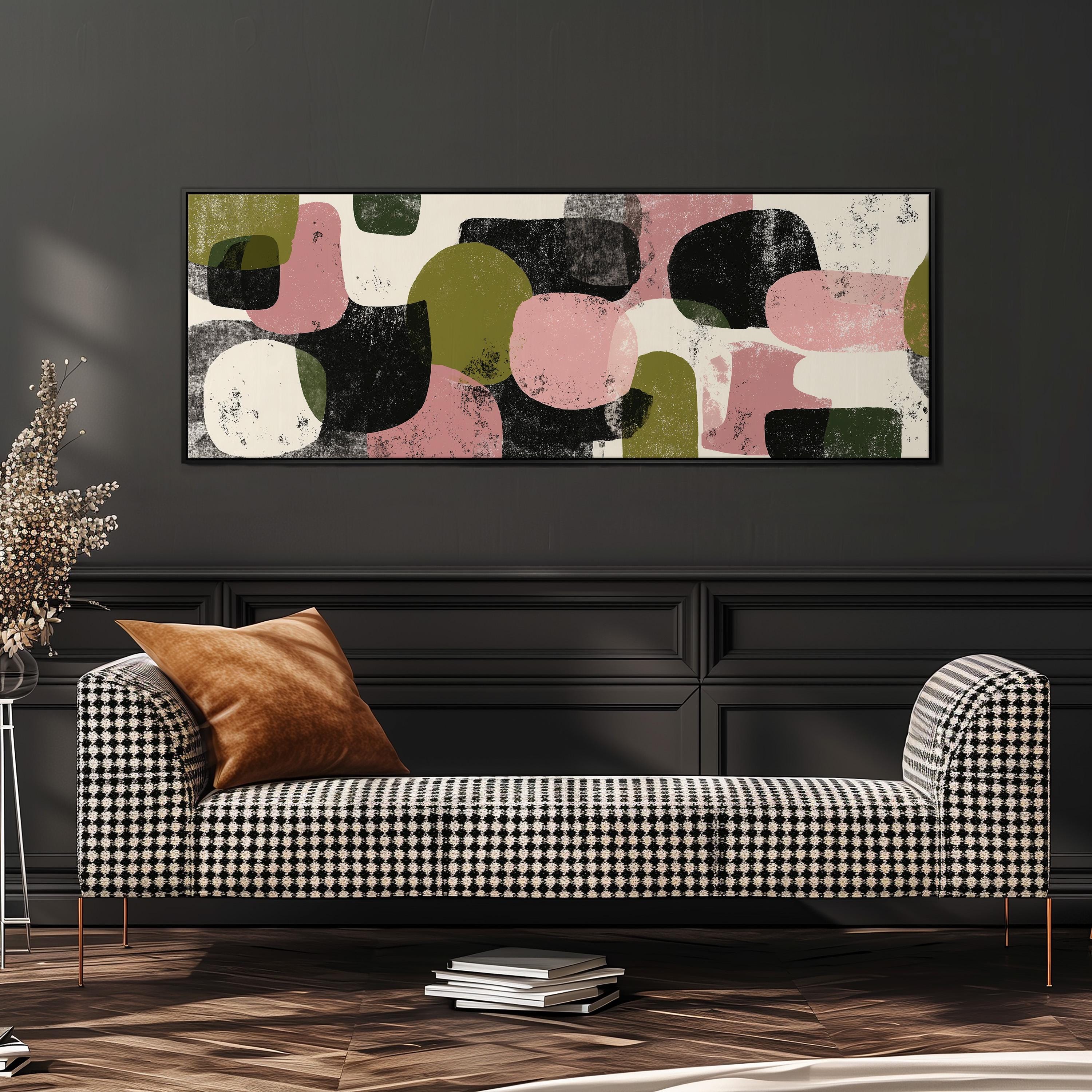 a modern living room with a black and white checkered sofa, a stack of books, and a large abstract painting on the wall.