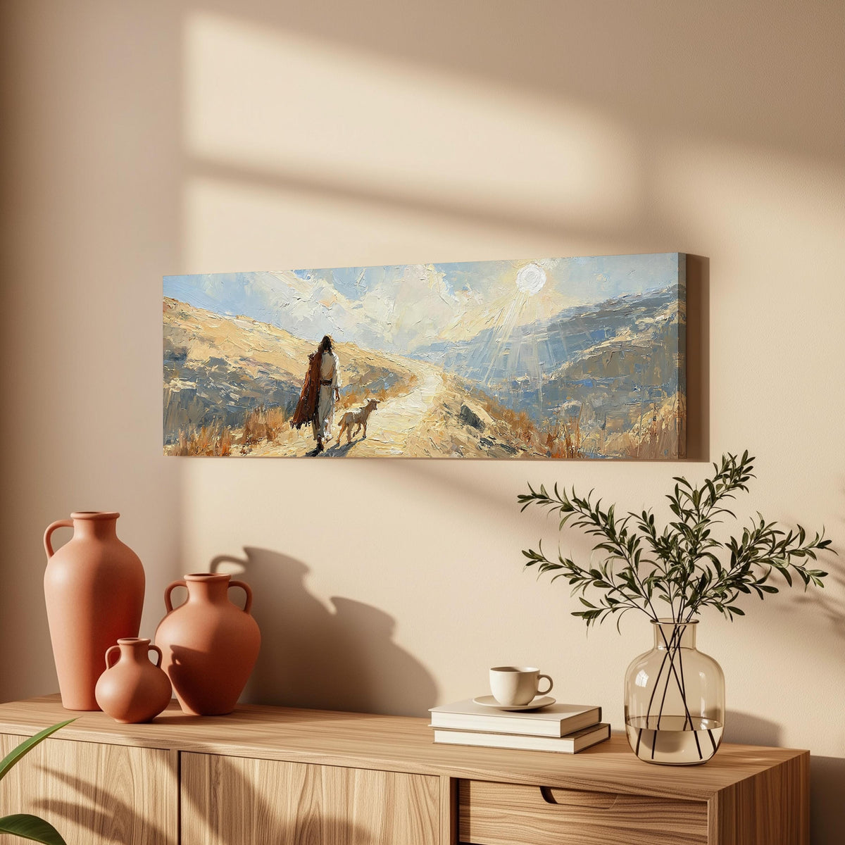 Jesus walking a sunlit hillside path with a sheep long horizontal canvas print above a wooden sideboard