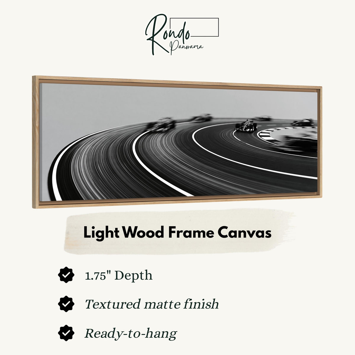 Race cars sweeping around a curve in black and white canvas print in a light wood floating frame