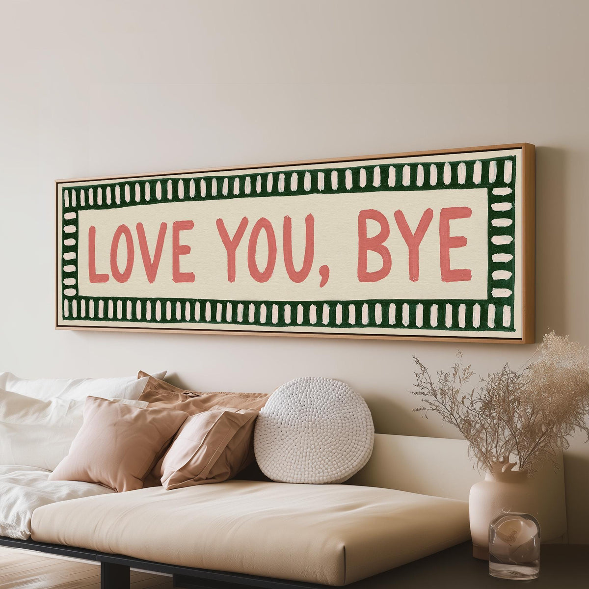 Love you, bye sign with a green border long horizontal canvas print above a sofa in a living room