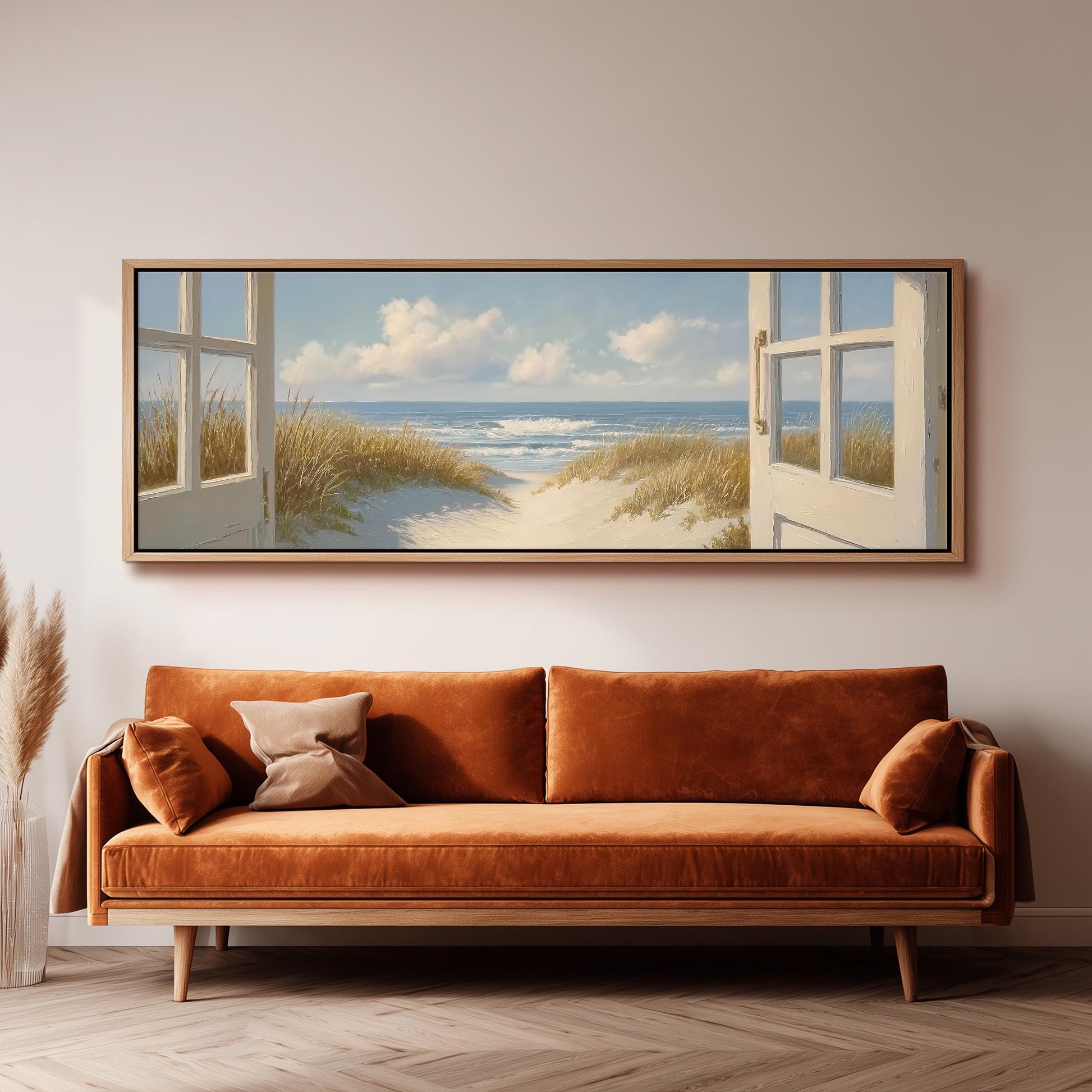 a large, framed painting of a beach scene with a view of the ocean through an open window.