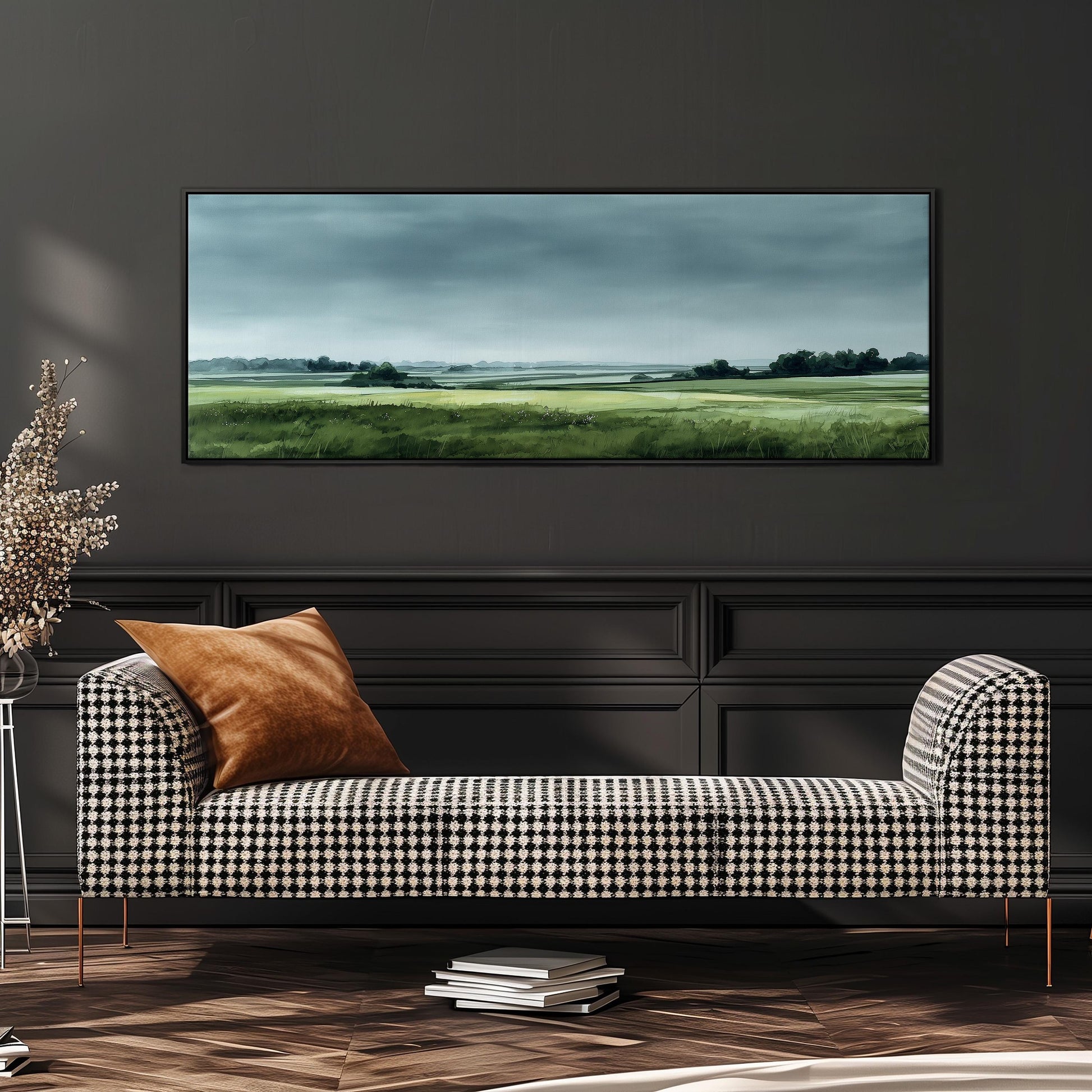 a black and white checkered sofa with a brown throw pillow, set against a dark wall with a large landscape painting hanging above it.