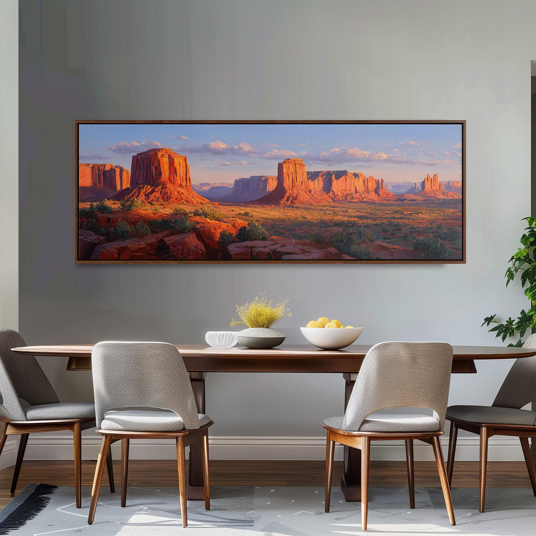 a large, framed painting of a desert landscape with towering red rock formations and a clear blue sky.