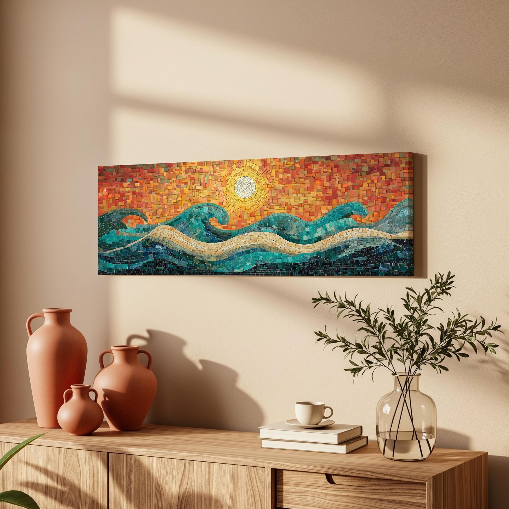 a wooden cabinet with a vase, a stack of books, and a plant on top. Above the cabinet, there is a large mosaic artwork depicting a sunset over the ocean.