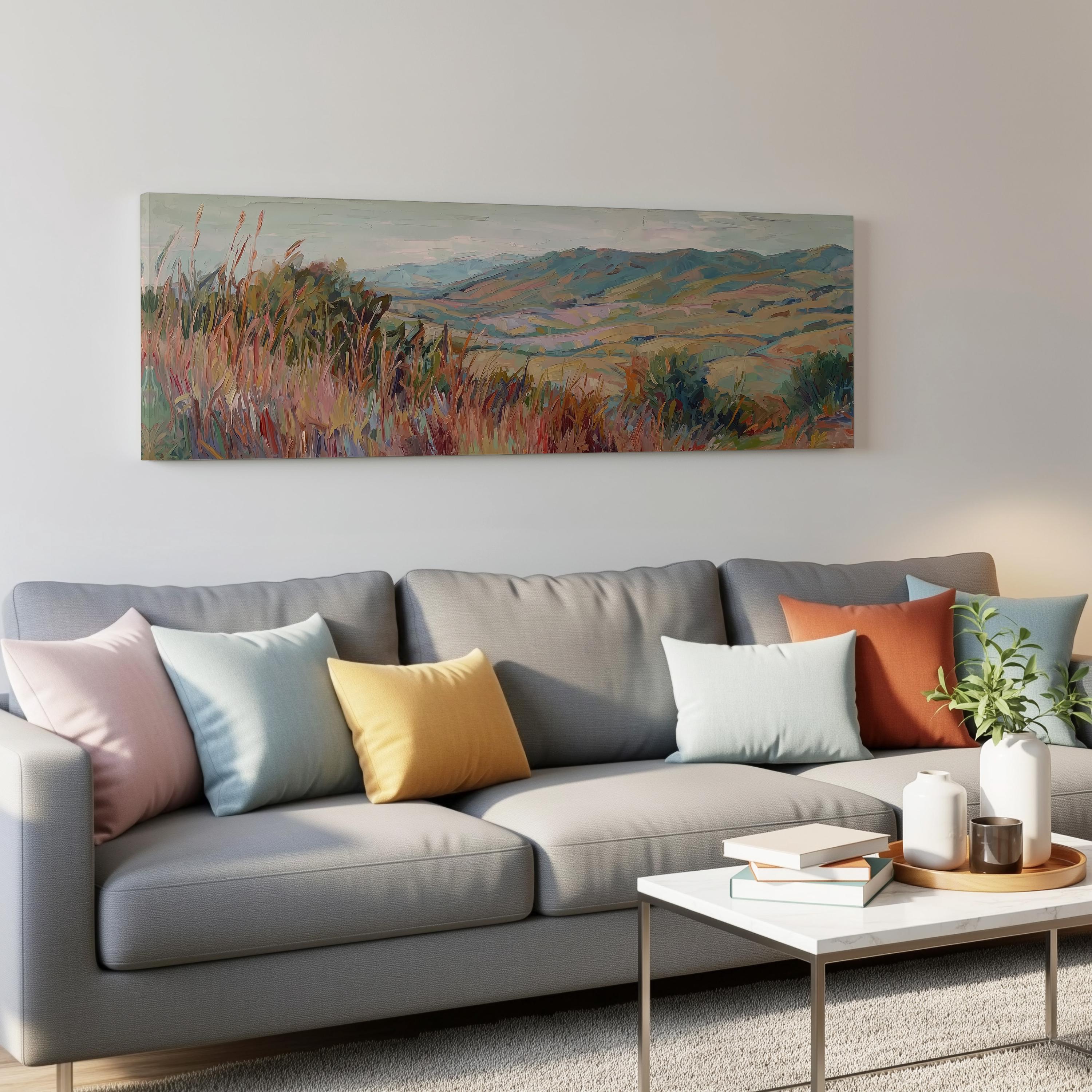 a cozy living room with a gray sofa adorned with colorful throw pillows, a white coffee table, and a painting of a countryside landscape hanging on the wall above the sofa.