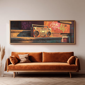 a large, framed painting of a vintage boombox on a wall above a brown sofa in a living room setting.