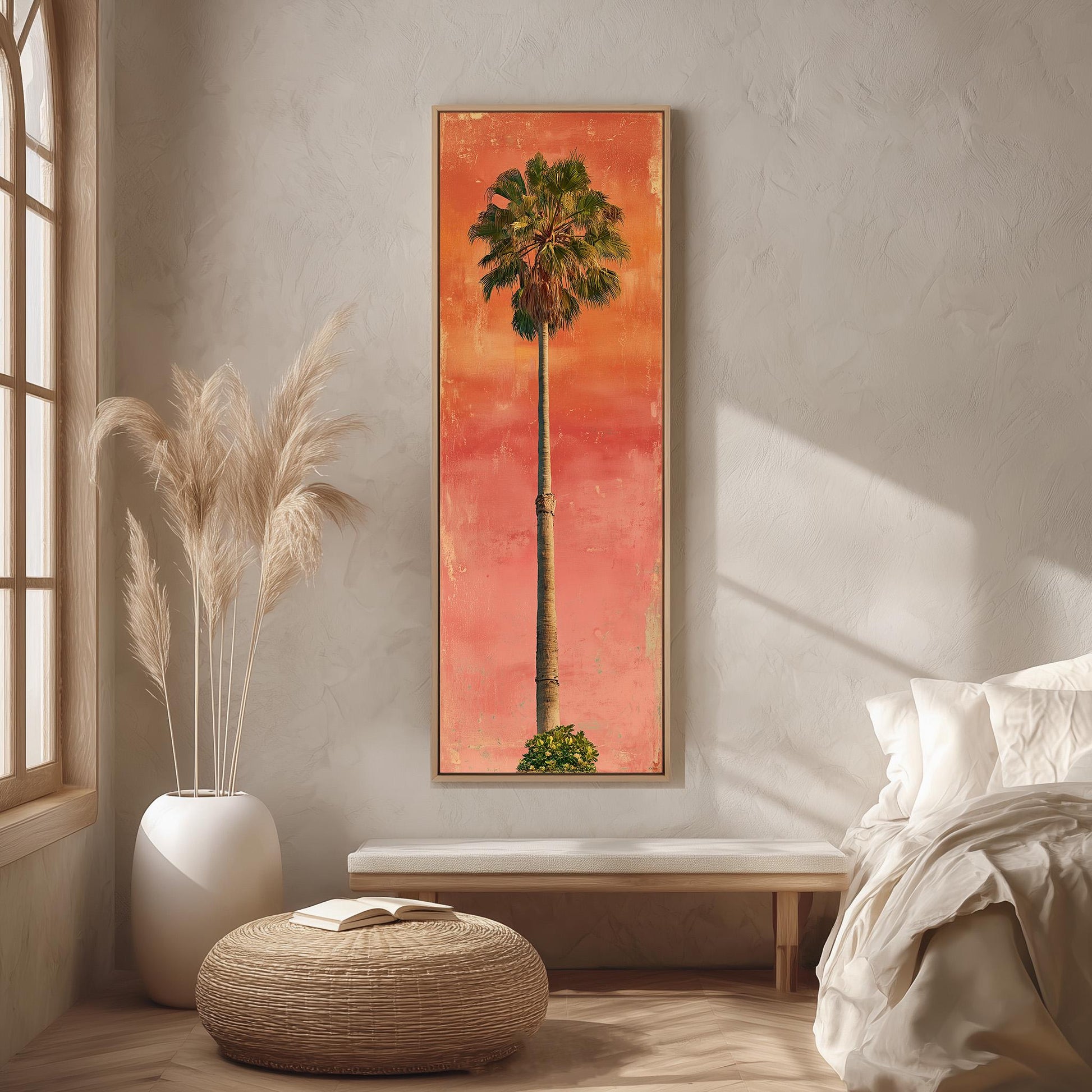 a large framed painting of a palm tree on a wall, with a wooden bench and a woven ottoman in the foreground.