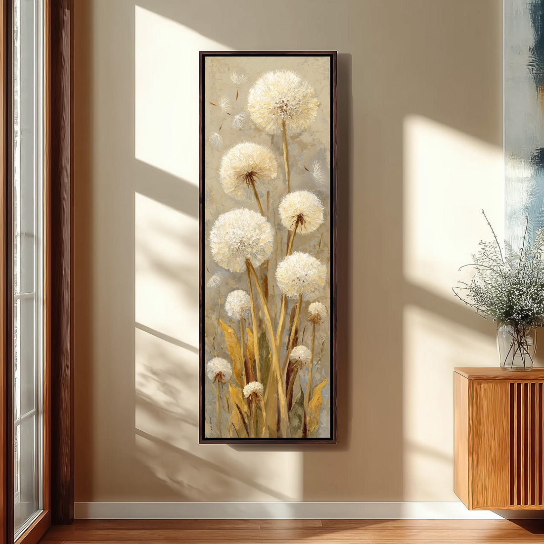 a large painting of dandelions hanging on a wall in a room with a wooden chair, a small table, and a window.