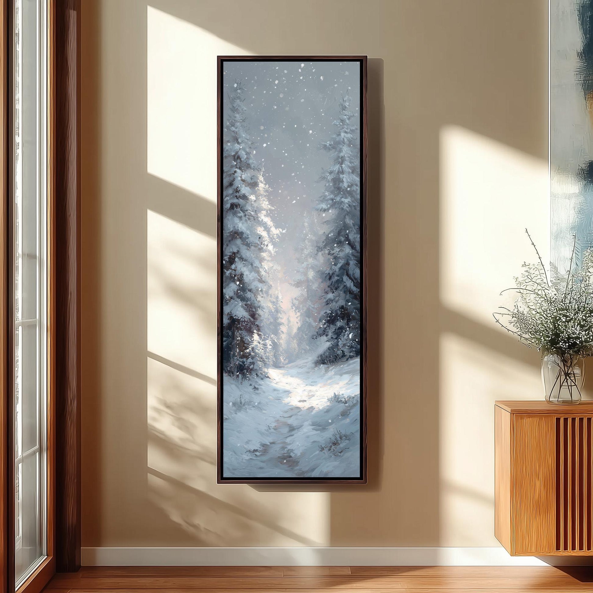 a large, framed painting of a snowy forest scene hanging on a wall.