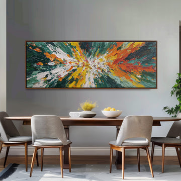 a dining room with a large, colorful abstract painting hanging on the wall above a wooden dining table. The table is set with a bowl of fruit and a vase of flowers, creating a welcoming and vibrant atmosphere. The room is furnished with four chairs, two on each side of the table, and a potted plant is visible in the background.