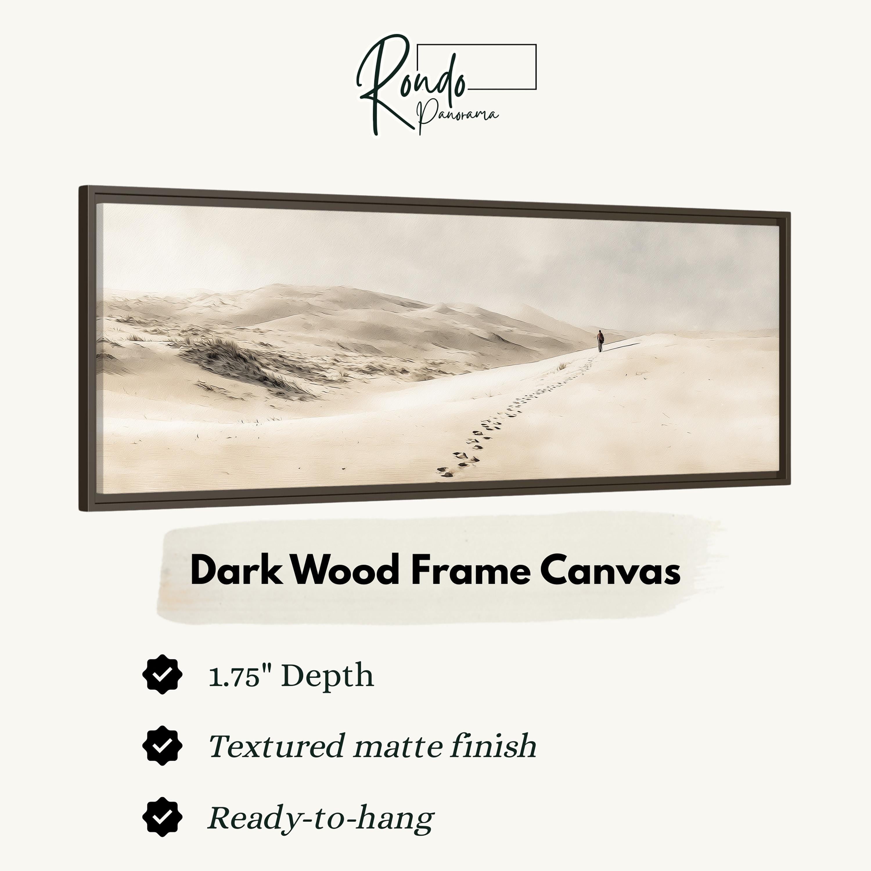 The image is a dark wood frame canvas depicting a lone figure walking along a path through a desert landscape.