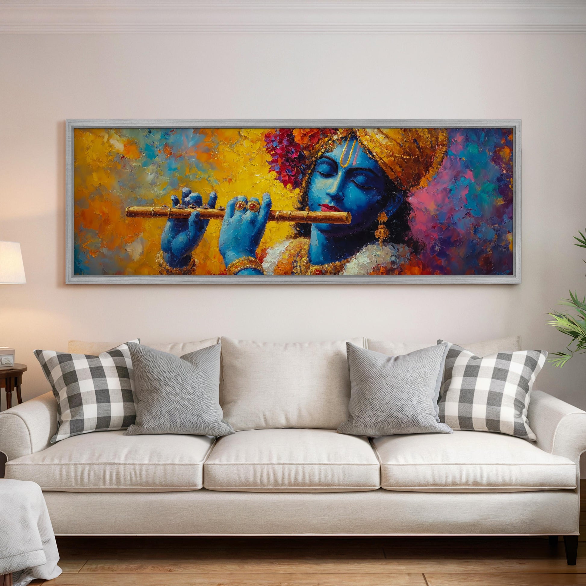 a large painting of a blue-skinned man playing a flute, hanging on a wall above a white couch with decorative pillows.