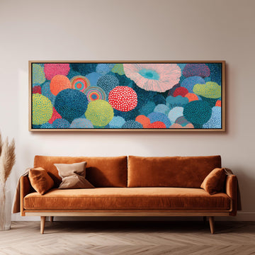 Coral spirals and dotted circles long horizontal canvas print above a sofa in a living room
