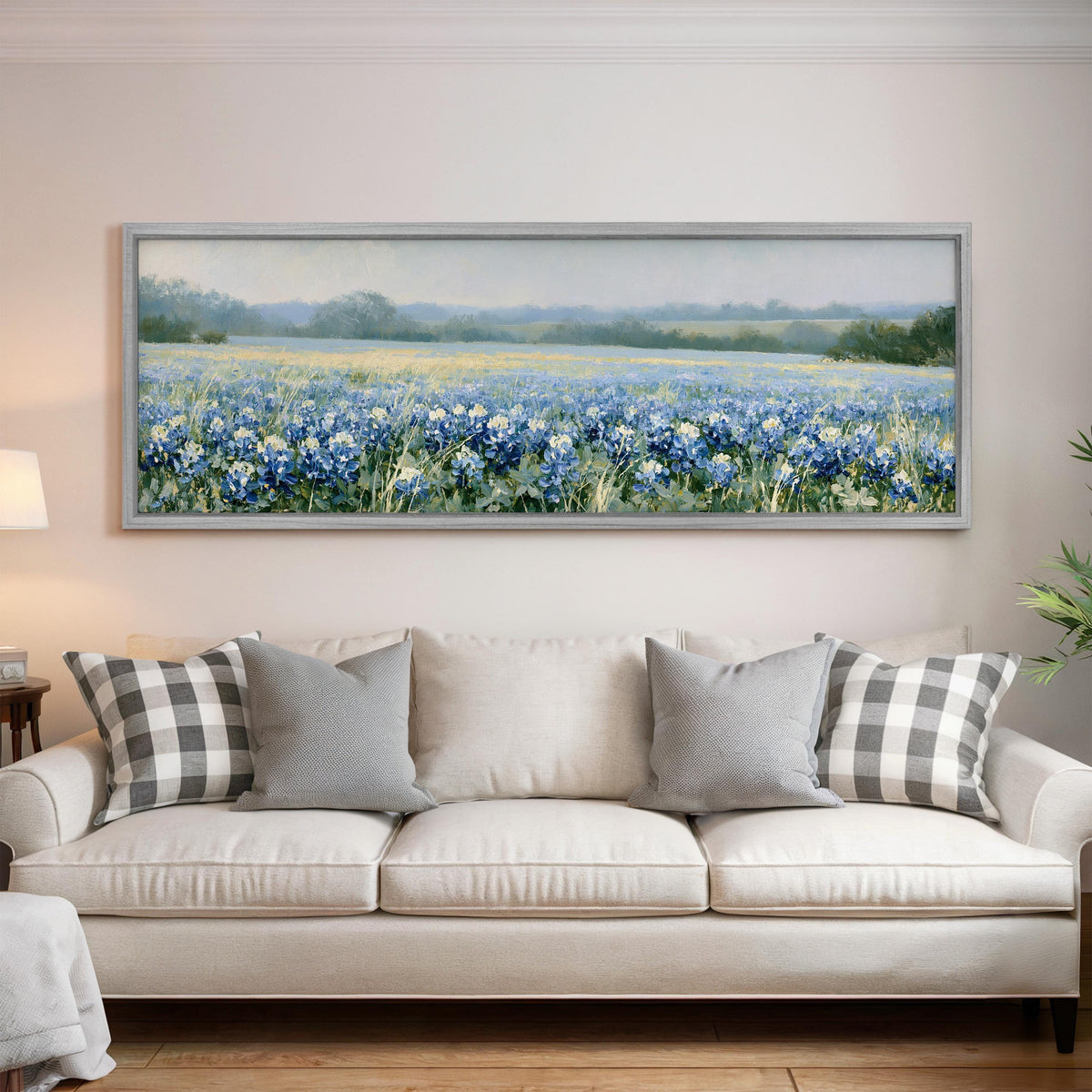 Field of bluebonnets panoramic canvas print above a white sofa in a bright living room
