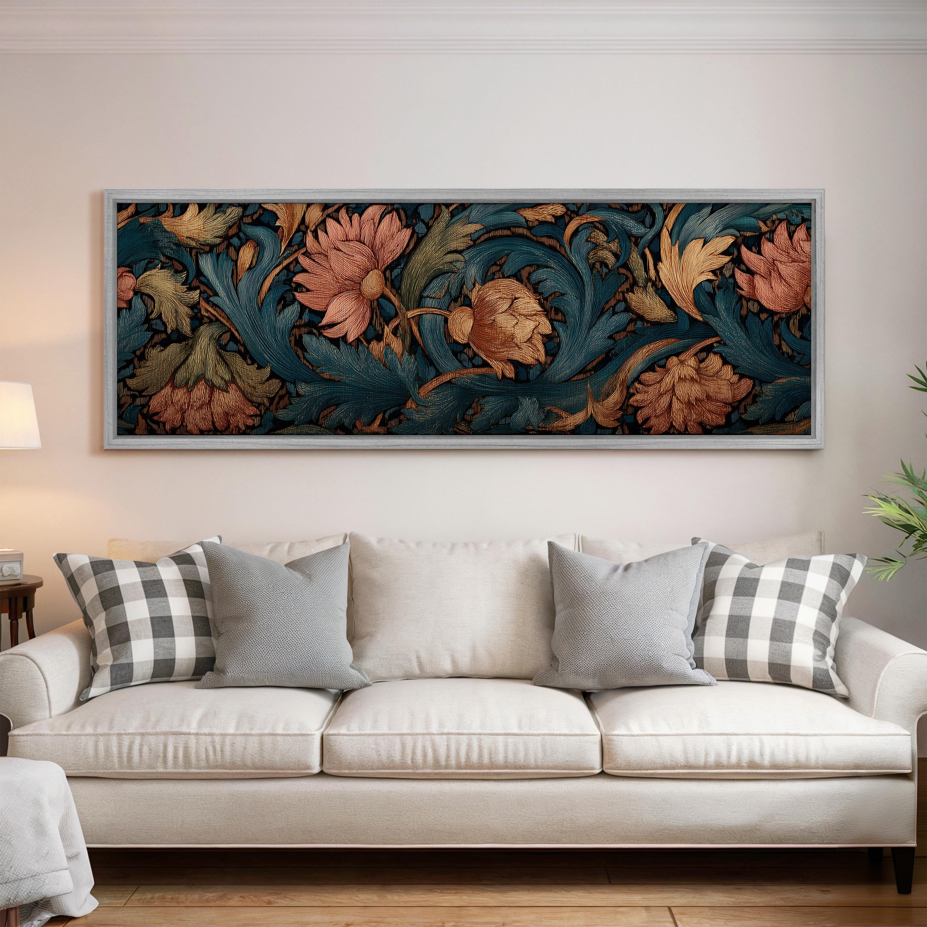 a large framed artwork hanging on a wall above a white sofa with decorative pillows.